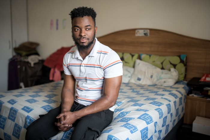 Grajevis Bakatunkanda, who has sickle cell anaemia, sits for a portrait in his bedroom in Wynberg, Cape Town, South Africa.