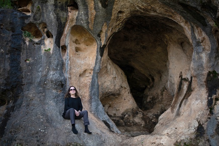 Israeli archaeologist Mina Weinstein-Evron outside a cave at the site of Mount Carmel, Nahal Me'arot Nature Reserve