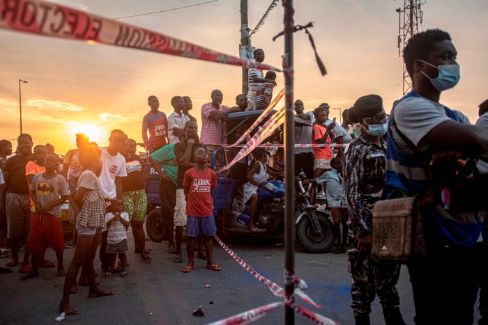 A crowd gathered at sunset to watch the count of ballots at a polling station in Ghana