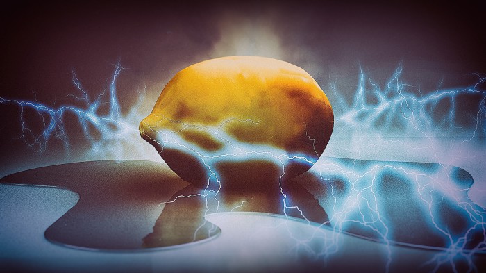 A lemon sits in a small pool water surrounded by flashes of electricity