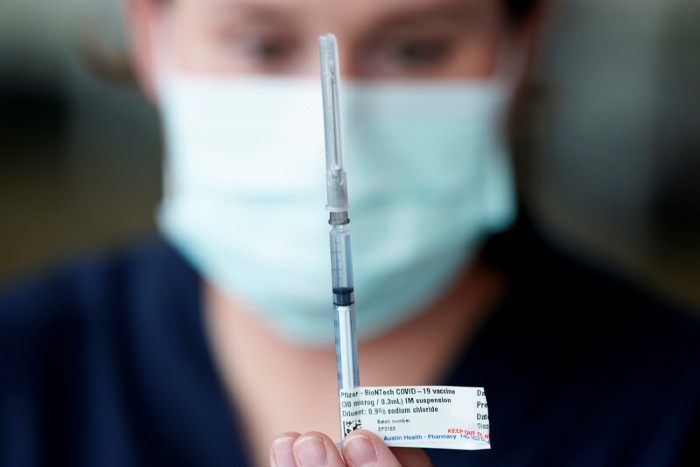 A healthcare professional prepares a dose of the Pfizer coronavirus vaccine