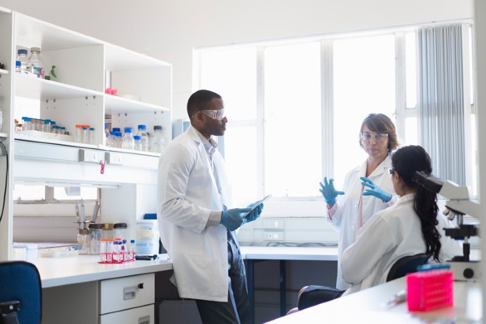 Scientists in a laboratory having a discussion.