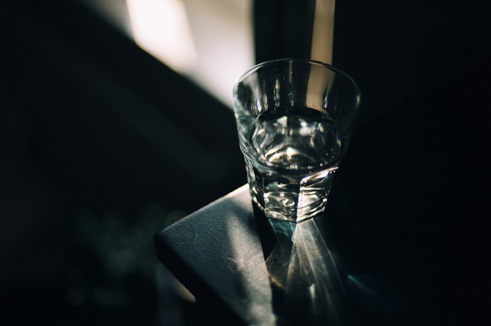 Glass of water on bedside table