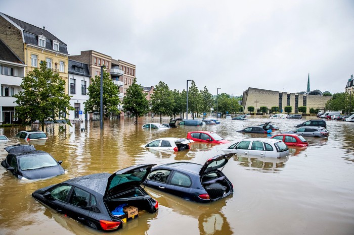 Cars are seen floating in a flooded street in Valkenburg, Netherlands.