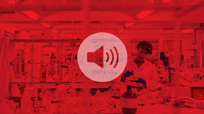 A young black scientist works in a lab with a red overlay and speaker icon