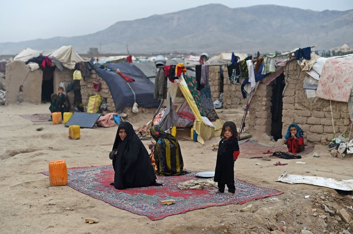 Afghan internally-displaced women and children at their tents at a refugee camp in the Herat province on February 20, 2022.