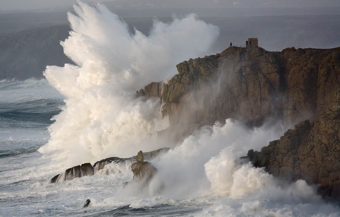 Massive waves breaking on headland, Cornwall, England.