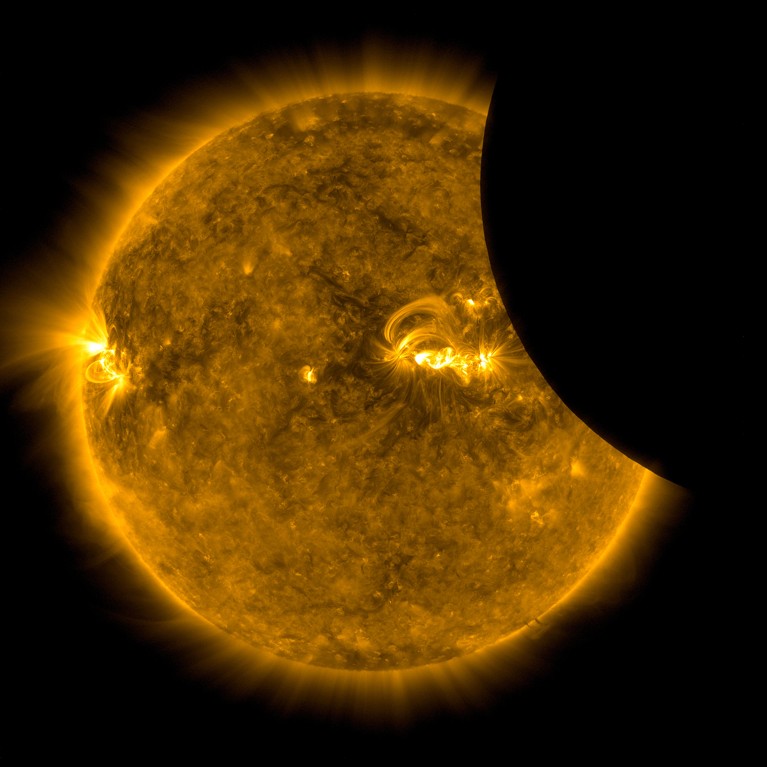 Image of the Moon transiting across the Sun in extreme ultraviolet light