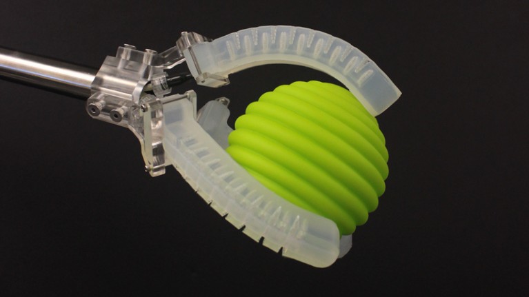 Soft robotic gripper holding a ball
