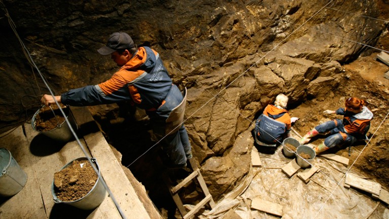 Archaeologists working at an excavation at the Denisova Cave