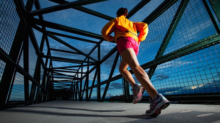 A woman jogging on a bridge