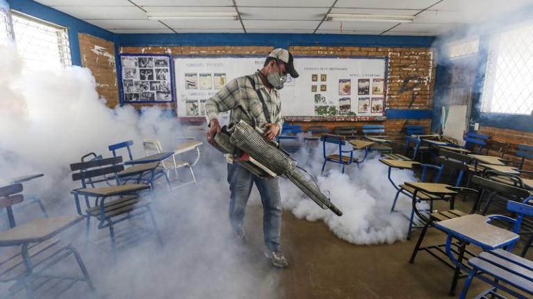 A worker fumigates a classroom in Nicaragua to combat the spread of Zika