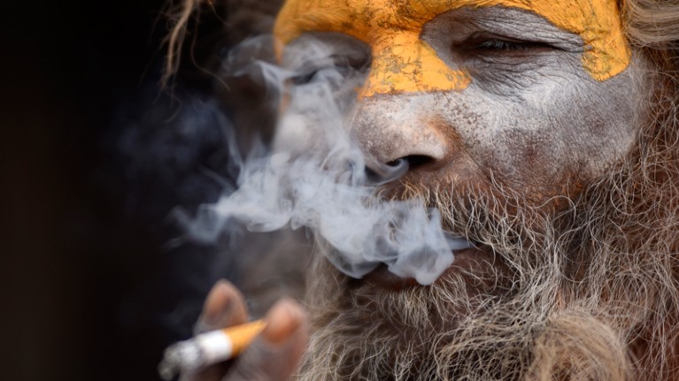 A Hindu Sadhu smoking cigarette