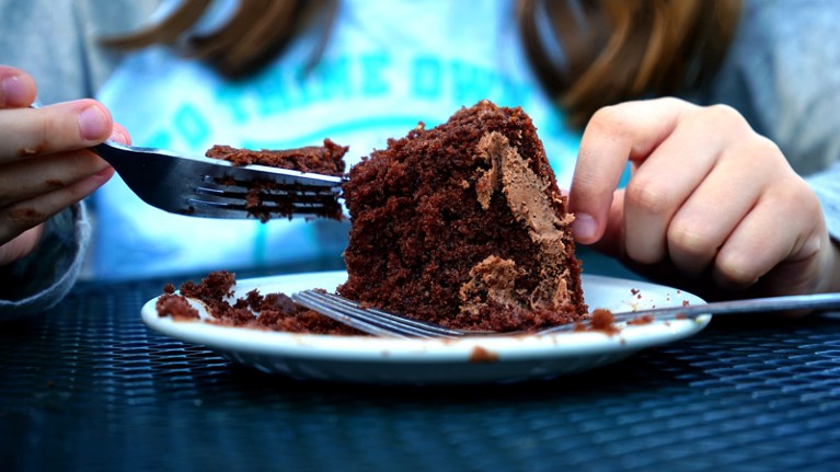 Eating chocolate cake with a fork