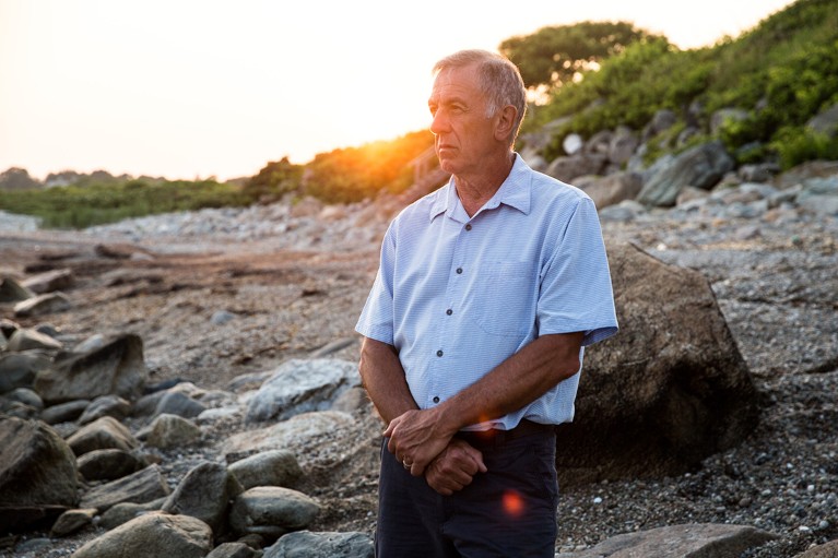 Dan Costas, now retired, gazes out towards the Rhode Island coastline at sunset.