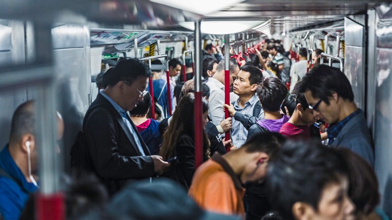 Commuters packed on an underground train in Hong Kong