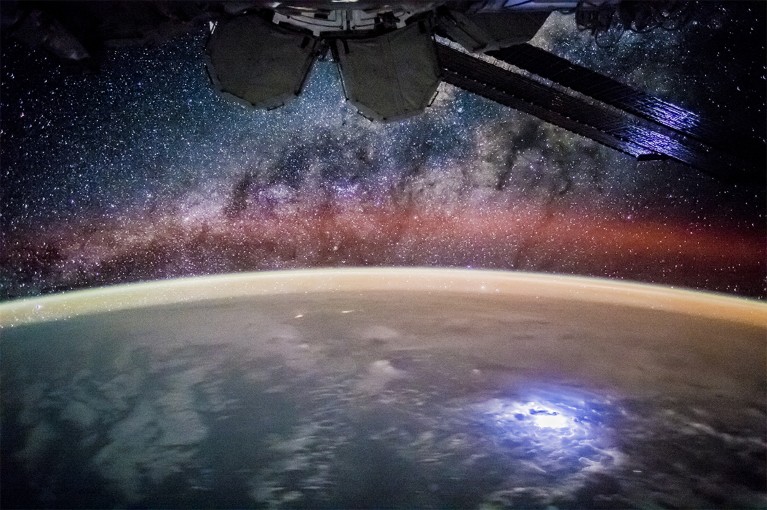 A beautiful starscape can be seen above the pacific ocean from the ISS (partially visible top centre)