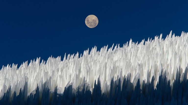 Columns of compact snow called Nieve penitente with moon