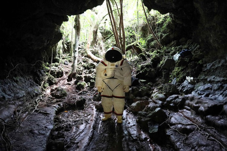 Peter Weiss, director of the Space Department of COMEX, tests a pressurized suit in a lava tunnel