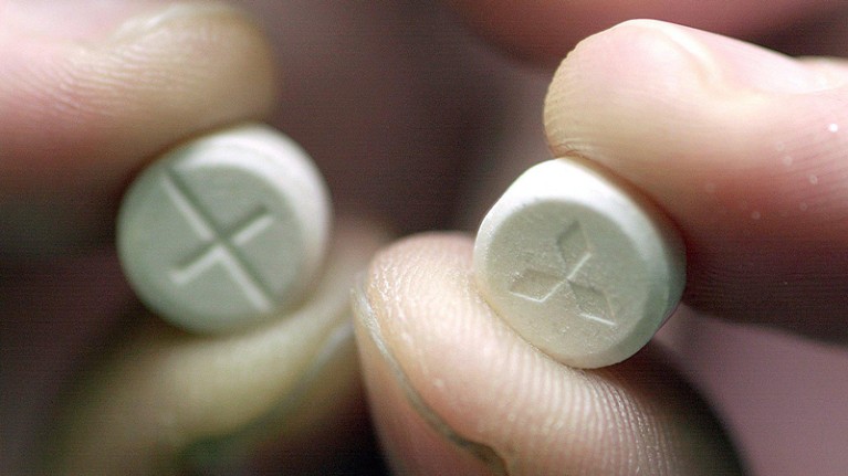 Person holding ecstasy pills