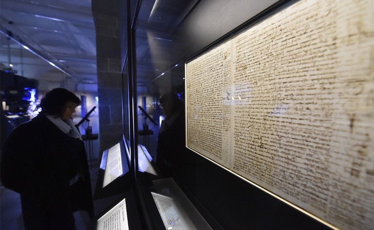 A woman looks at da Vinci's Codex Leicester at the exhibition