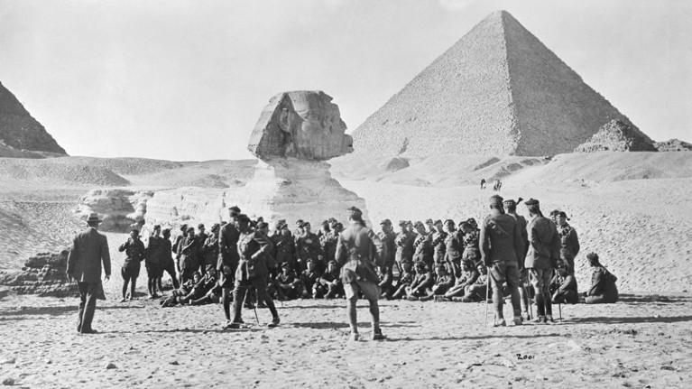 A group of World War One soldiers in front of the Sphinx and Pyramids of Egypt