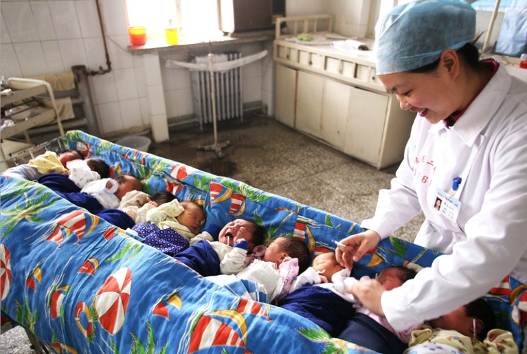 A nursing worker takes care of new-born babies at a hospital in China