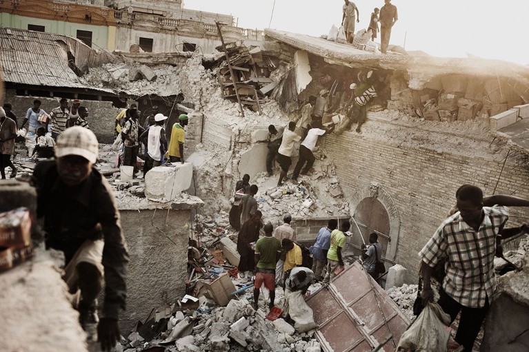 Haitian try to salvage any valuables in the rubble after an earthquake.