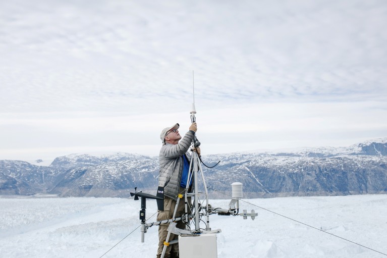 Researchers repairs a broken GPS module at a research station in Greenland