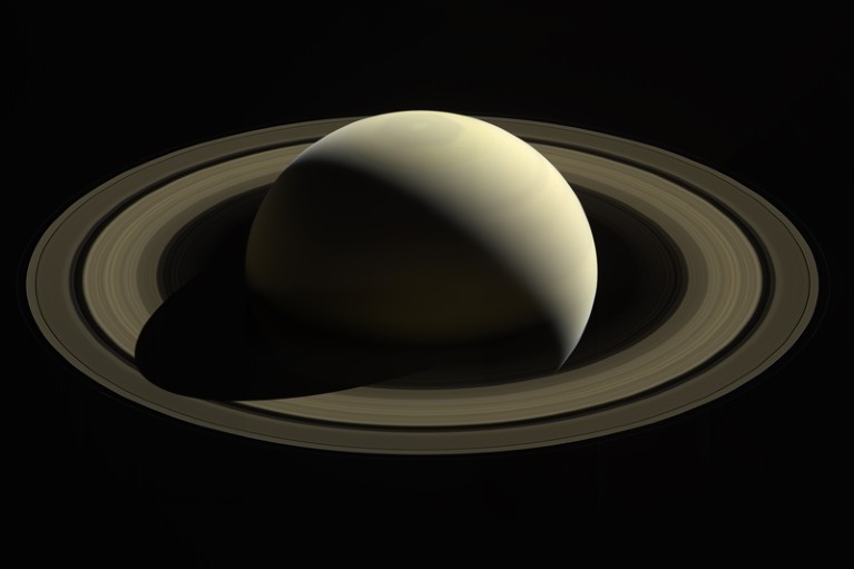 A view captured by Cassini of Saturn casting a shadow across its main rings