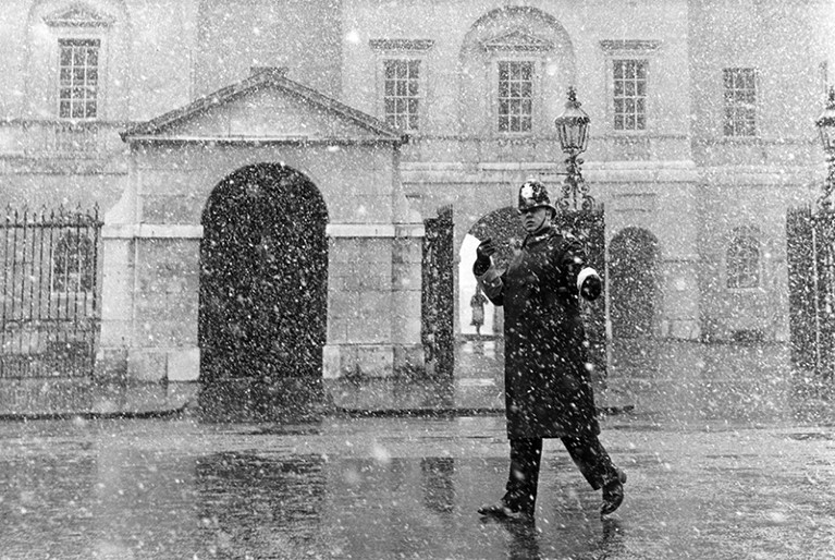 A traffic policeman on duty in the snow, outside Horseguards in Whitehall, 1968.