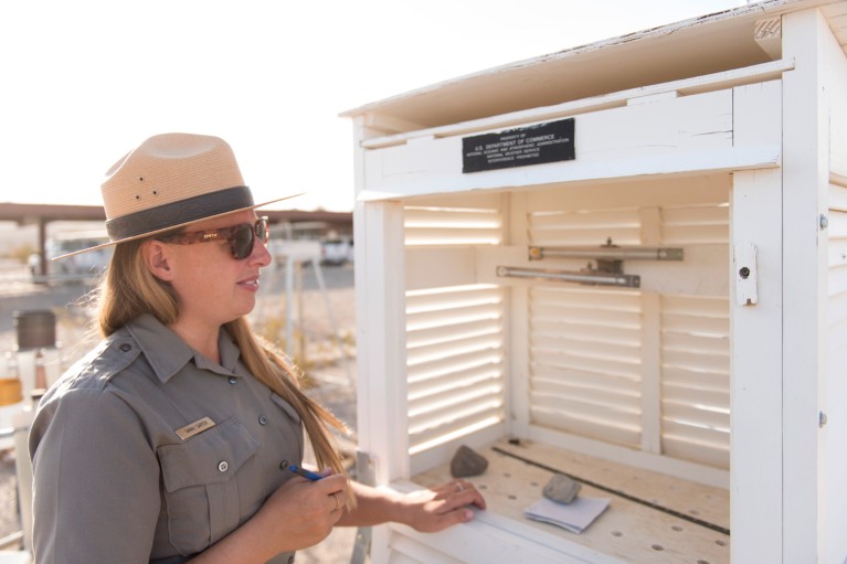 Park ranger Sarah Carter checks the thermometers at the Furnace Creek Visitor Centre weather station, Death Valley