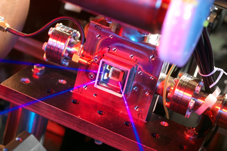 An ion trap on a microchip with lasers shining on it.