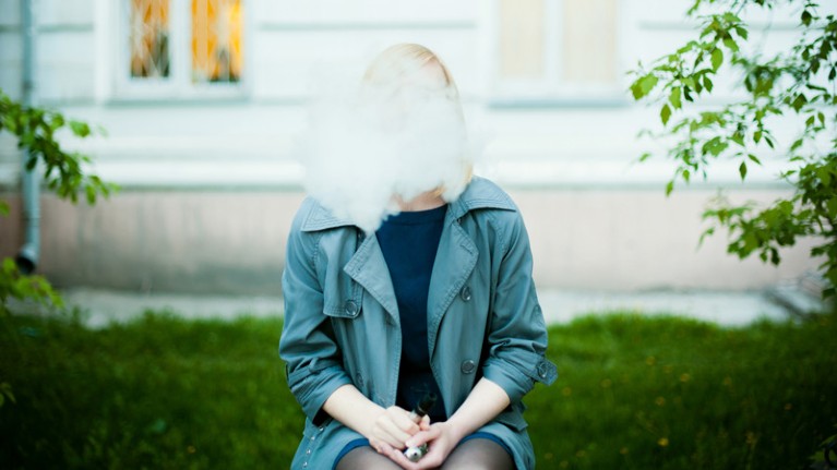 Young Woman Smoking Electronic Cigarette.