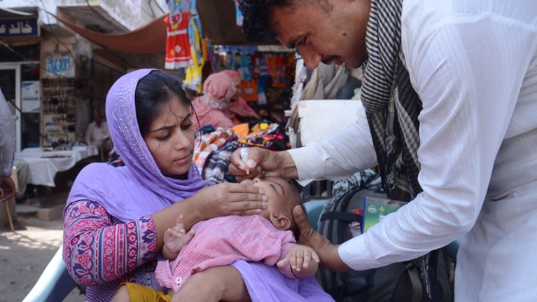 Pakistani polio vaccination team administering polio drops.
