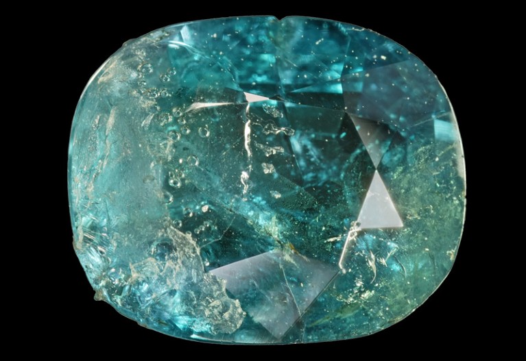 A green oval-shaped gem on a black background.