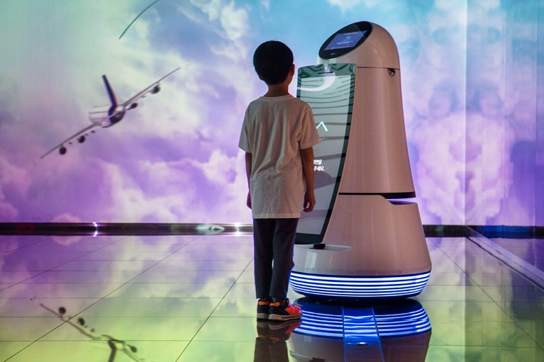 A young boy communicates with a robot on display at Incheon International Airport