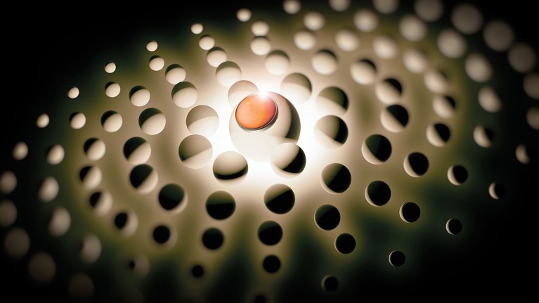 A red button sits amid a sea of spheres