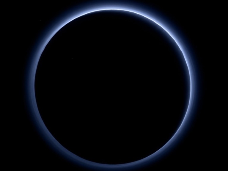 Black disk with thin blue/white glow around it and black background.