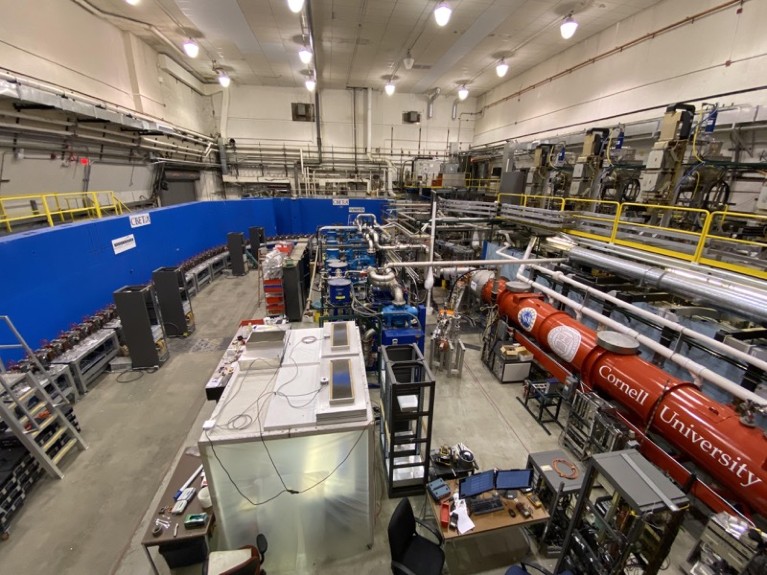 Linear particle accelerator housed in high-ceilinged laboratory.
