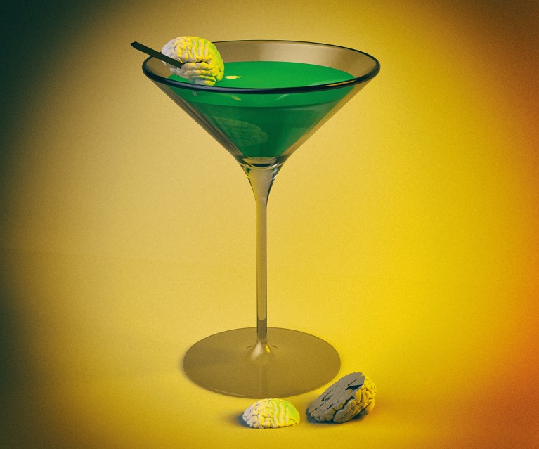 A cocktail glass containing a green liquid, with a small brain on a cocktail stick perched on the rim