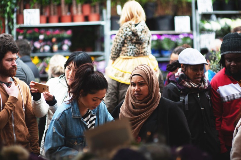 A diverse crowd at a flower market in London