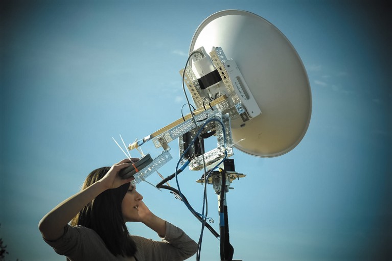 Jessica Frantz holding an atmospheric sampling receiver