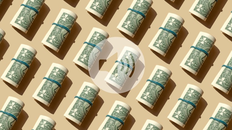 Roll of American dollars banknotes on a beige background