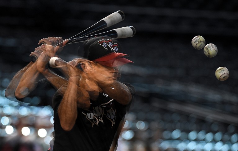 A multiple exposure photograph of a baseball player hitting a ball