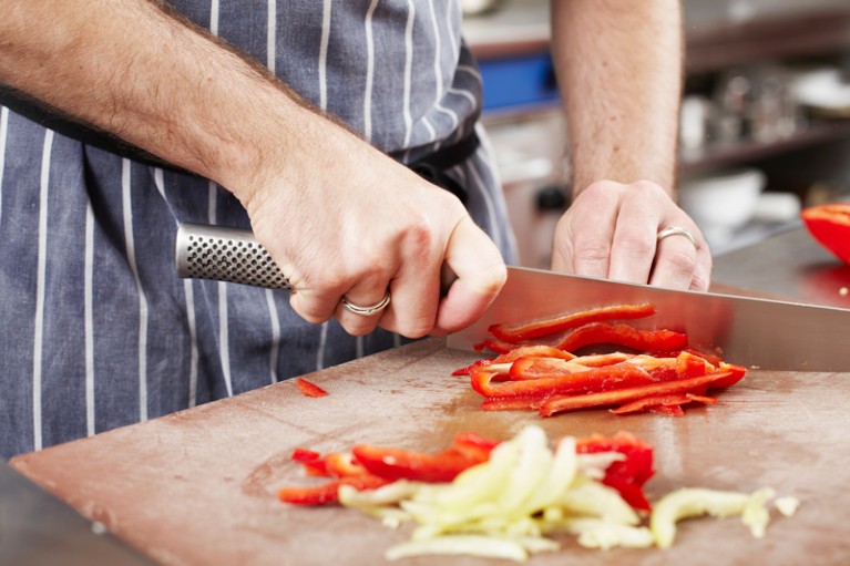 Chef chopping vegetables in a kitchen
