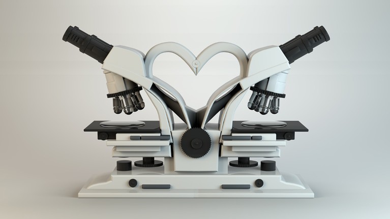 Two microscopes sit back to back, forming a heart shape between them