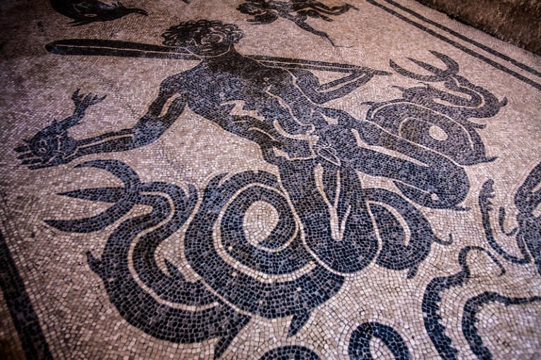 Floor mosaic from the ancient Roman town of Herculaneum showing a male figure with a fish in his hand