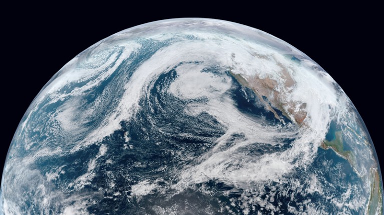 Satellite image showing an arc of clouds stretching from Hawaii to the Pacific Northwest