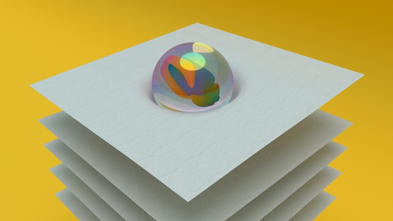 A marble nestles into the centre of grey sheet poised above several other sheets